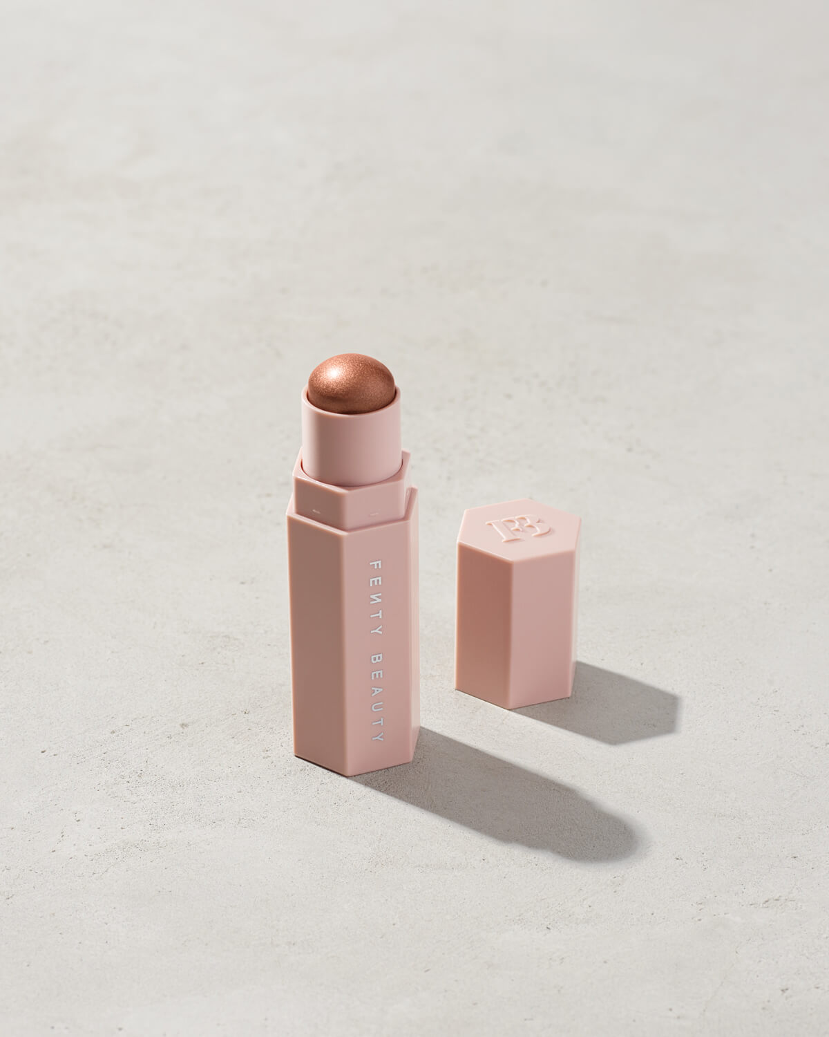 Match Stix Shimmer Skinstick shown in shade Sinamon on a concrete background.
