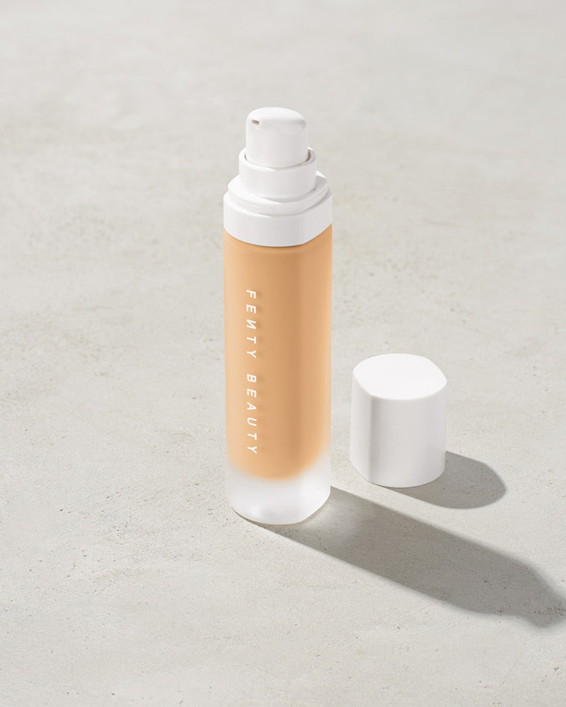 open bottle of Fenty Beauty Pro Filt'r Soft Matte Longwear Foundation with pump dispenser in shade #190 on concrete background