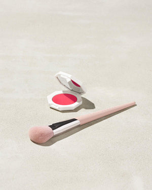 Cheeks Out Freestyle Cream Blush shown in shade Strawberry Drip with Face Shaping Brush 125