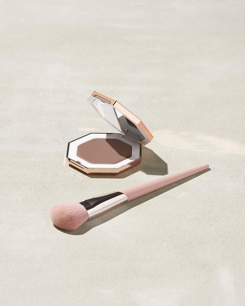 Cheeks Out Freestyle Cream Bronzer shown in shade Amber with Face Shaping Brush 125
