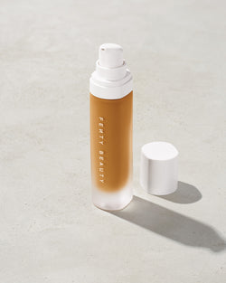 open bottle of Fenty Beauty Pro Filt'r Soft Matte Longwear Foundation with pump dispenser in shade 350 on concrete background open bottle of Fenty Beauty Pro Filt'r Soft Matte Longwear Foundation with pump dispenser in shade 350 on concrete background