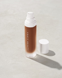 open bottle of Fenty Beauty Pro Filt'r Soft Matte Longwear Foundation with pump dispenser in shade 470 on concrete background open bottle of Fenty Beauty Pro Filt'r Soft Matte Longwear Foundation with pump dispenser in shade 470 on concrete background