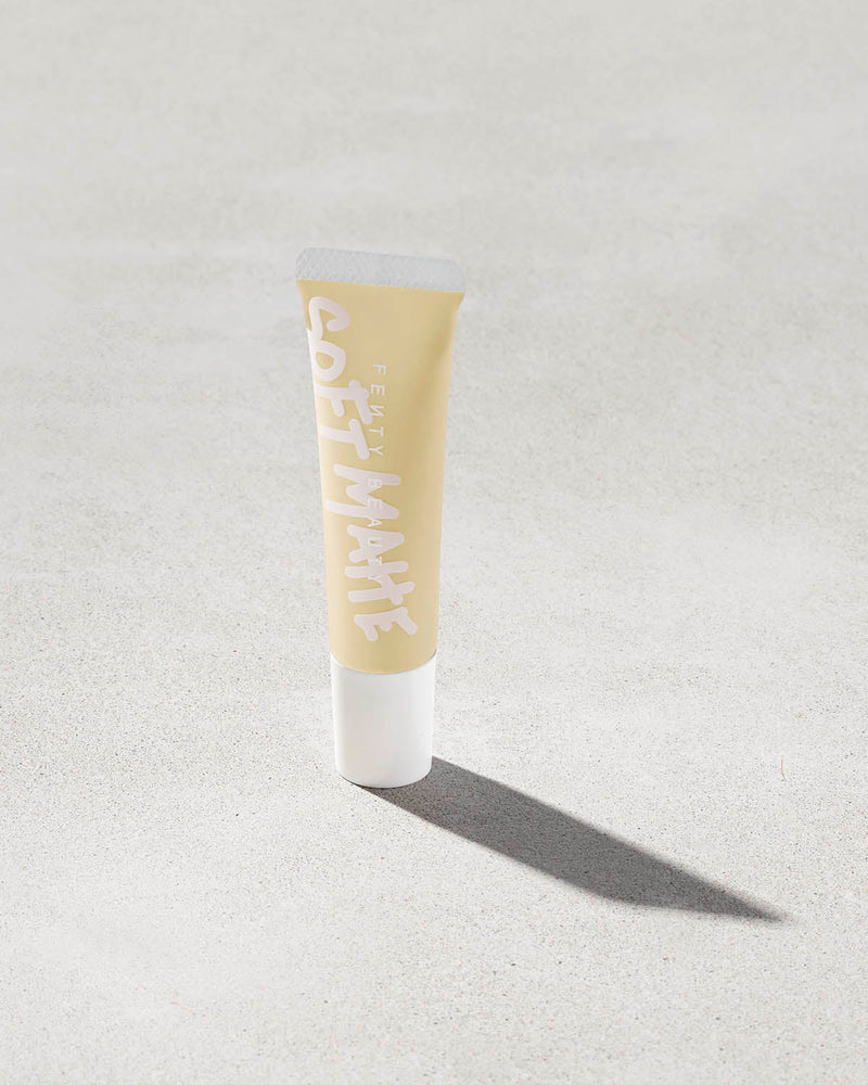 tube of Fenty Beauty Pro Filt'r Mini Soft Matte Longwear Foundation in shade #105 on concrete background