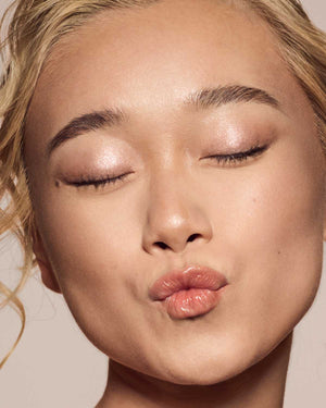 light skin toned model wearing gloss bomb universal lip luminizer in Fenty Glow