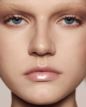 light skin toned model wearing gloss bomb universal lip luminizer in $weetmouth