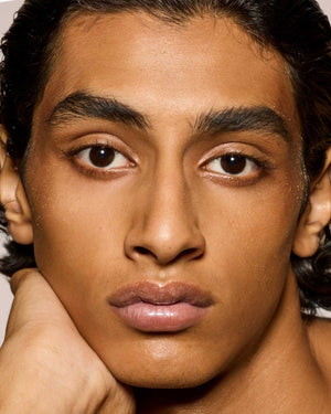 medium skin toned model wearing gloss bomb universal lip luminizer in $weetmouth