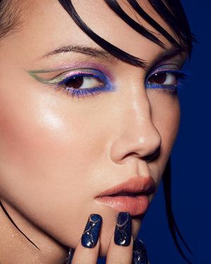 Model wearing Fenty Beauty Hella Thicc Mascara in shade Ka-bluey and Chrome Catch'r Eyeliner in shade Anomo'lit.