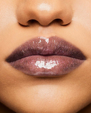 Product shot of Fenty Beauty Gloss Bomb Universal Lip Luminizer and packaging in limited edition Arcane collection shade Kaboom.