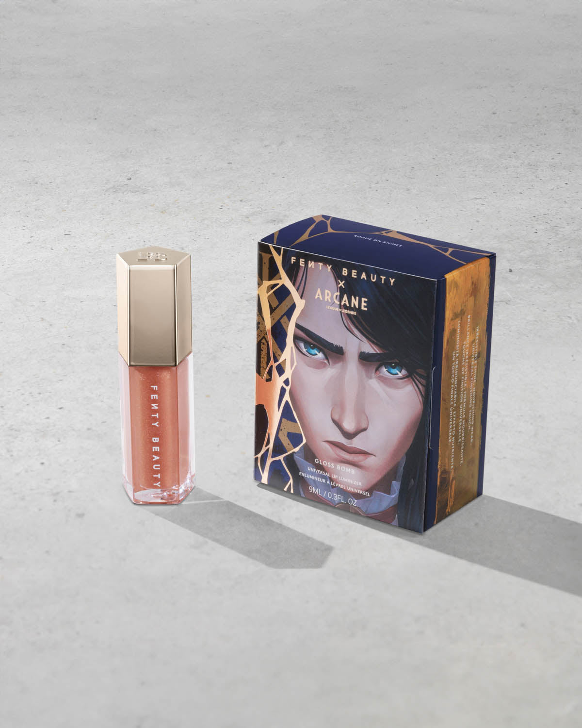Product shot of Fenty Beauty Gloss Bomb Universal Lip Luminizer and packaging in limited edition Arcane collection shade Rogue on Riches.