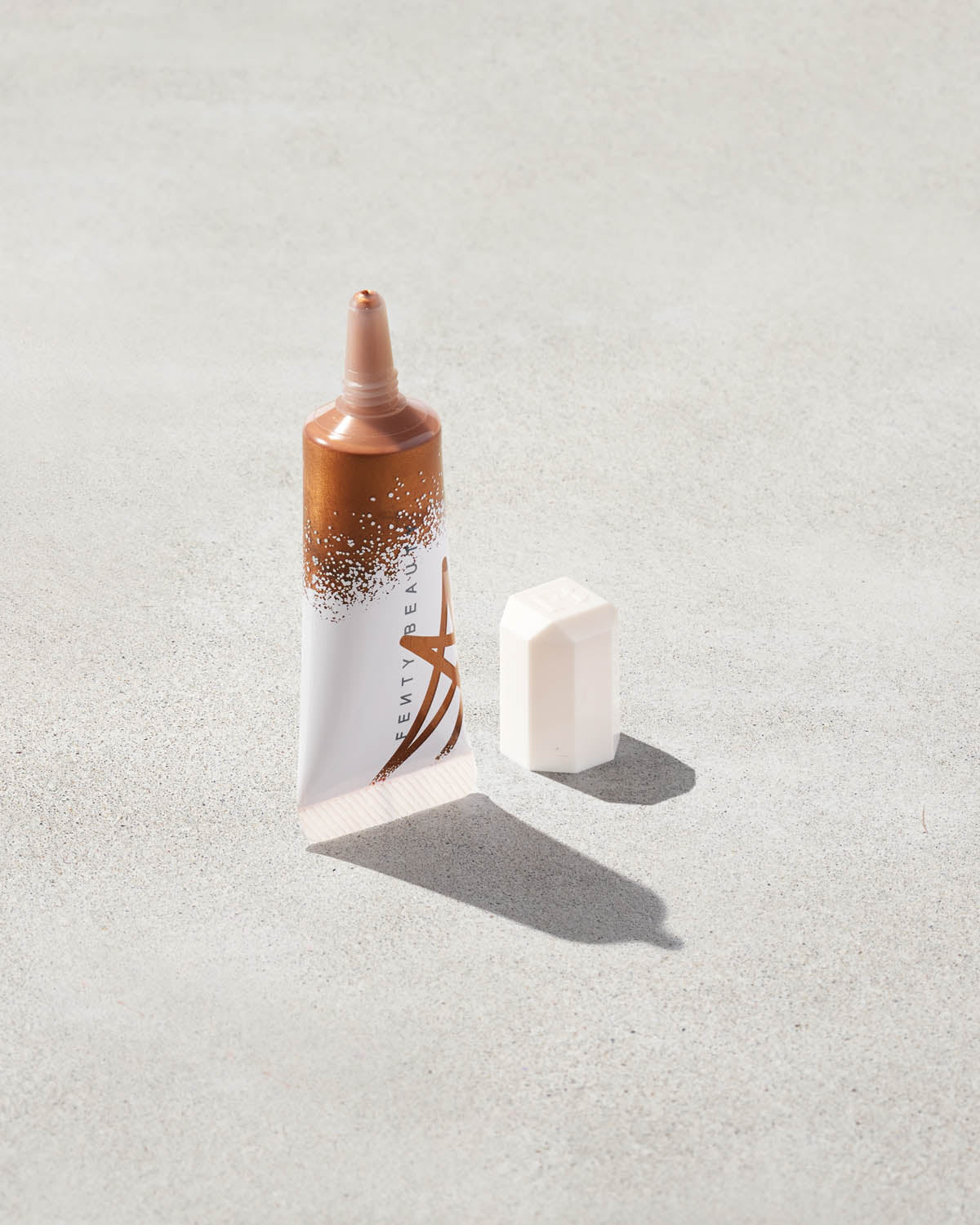 Tube of liquid highlighter in copper gold shade, Honey Hawtie.