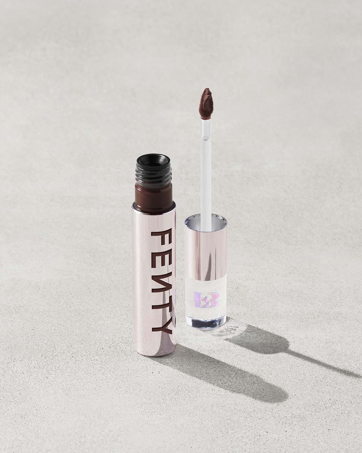An open Fenty Icon Velvet lipstick tube on a light background.
