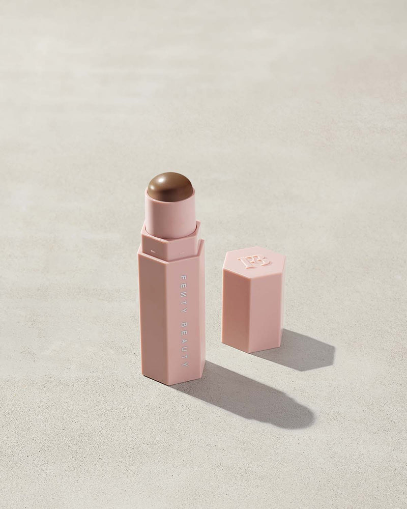 Opened Match Stix Contour Skinstick in the shade Suedish container on a grey background.