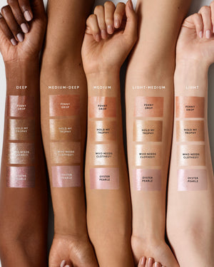 Arm swatch of Body Lava Body Luminizer on light, light medium, medium, medium deep, and deep skin tones.