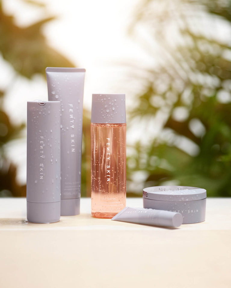 Fenty Skin Start'r Set of five skin care products with tropical background Fenty Skin Start'r Set of five skin care products with tropical background