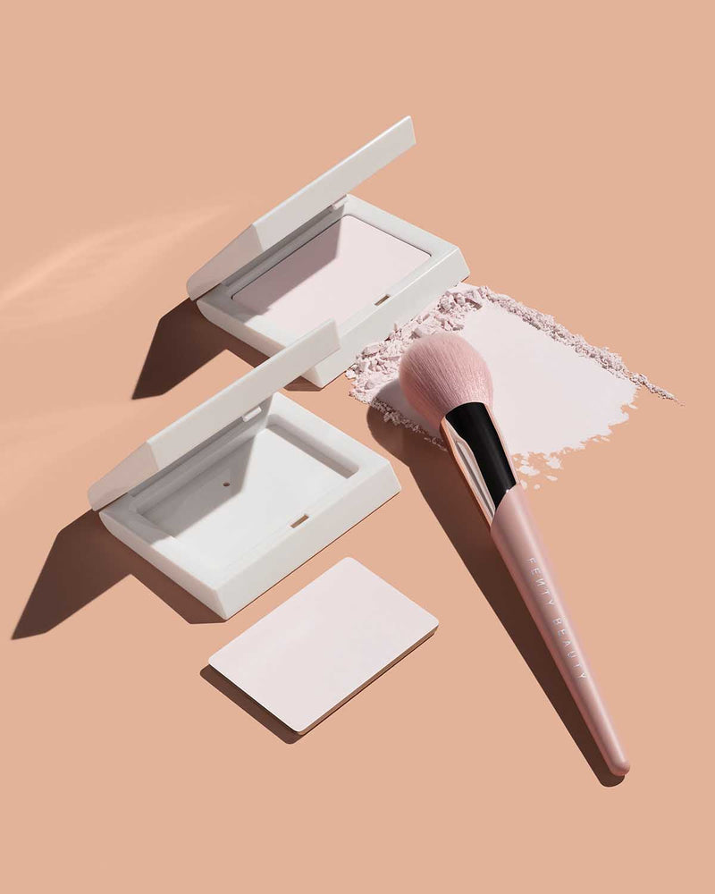 Invisimatte Instant Setting + Blotting Powder with open packaging, Powder Puff Setting Brush 120, empty packaging, and Invismatte Instant Setting + Blotting Powder refill shown on a peach background.