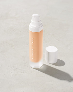 open bottle of Fenty Beauty Pro Filt'r Soft Matte Longwear Foundation with pump dispenser in shade #120 on concrete background