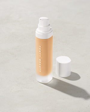 open bottle of Fenty Beauty Pro Filt'r Soft Matte Longwear Foundation with pump dispenser in shade #190 on concrete background