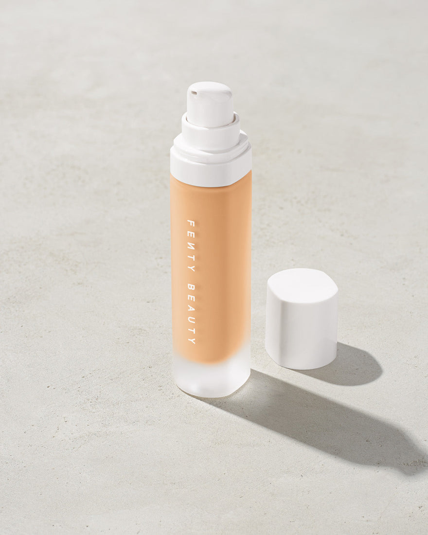 open bottle of Fenty Beauty Pro Filt'r Soft Matte Longwear Foundation with pump dispenser in shade #200 on concrete background