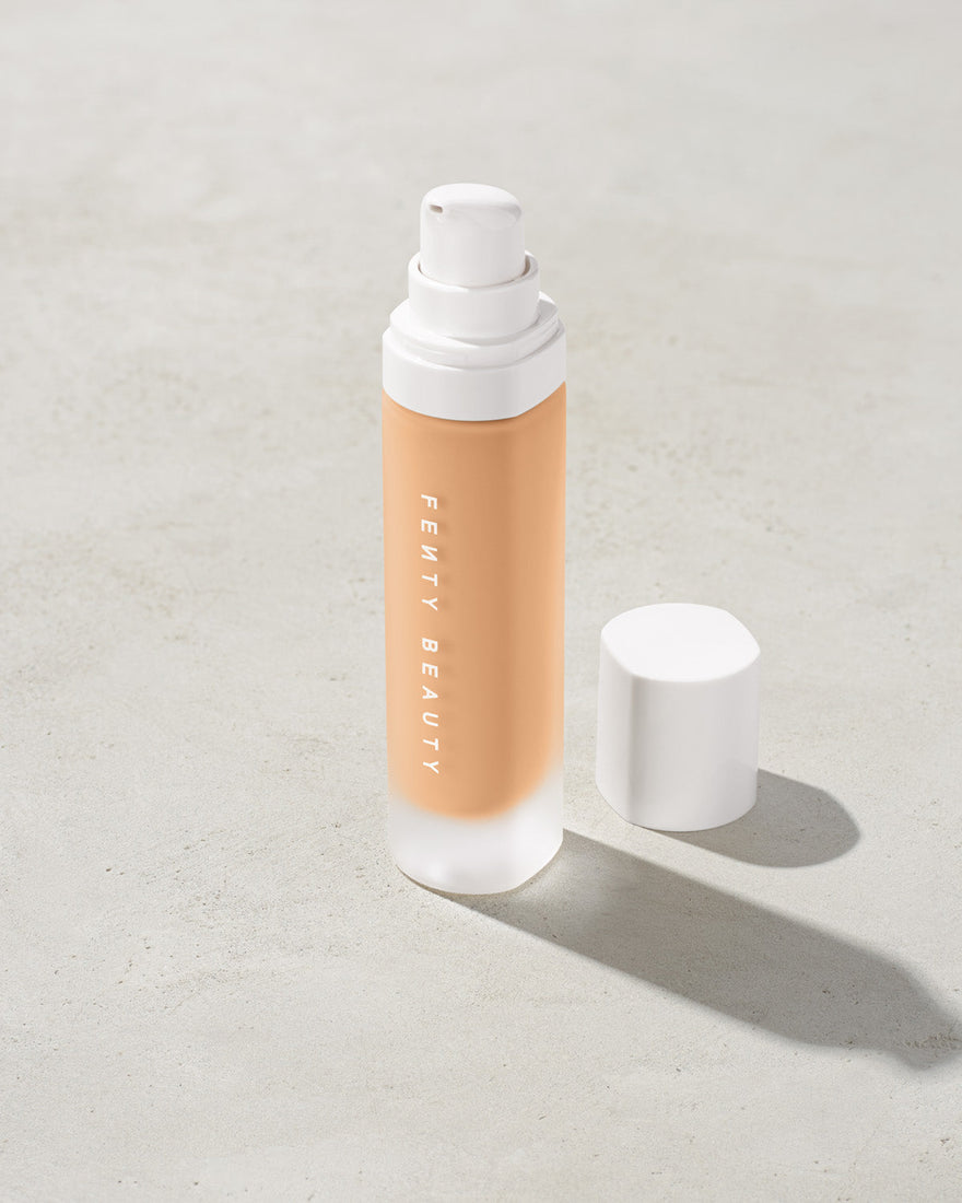 open bottle of Fenty Beauty Pro Filt'r Soft Matte Longwear Foundation with pump dispenser in shade #220 on concrete background