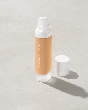 open bottle of Fenty Beauty Pro Filt'r Soft Matte Longwear Foundation with pump dispenser in shade #240 on concrete background