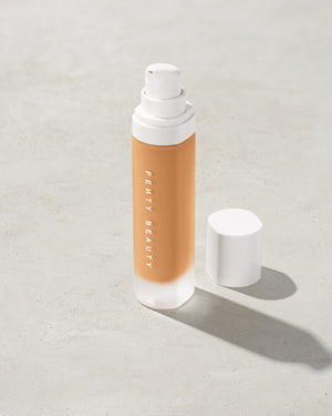 open bottle of Fenty Beauty Pro Filt'r Soft Matte Longwear Foundation with pump dispenser in shade #280 on concrete background