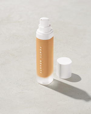 open bottle of Fenty Beauty Pro Filt'r Soft Matte Longwear Foundation with pump dispenser in shade #290 on concrete background