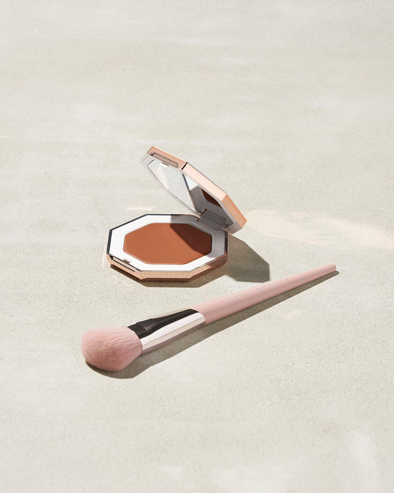 Cheeks Out Freestyle Cream Bronzer shown in shade Hunnie Glaze with Face Shaping Brush 125