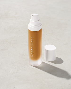 open bottle of Fenty Beauty Pro Filt'r Soft Matte Longwear Foundation with pump dispenser in shade 350 on concrete background