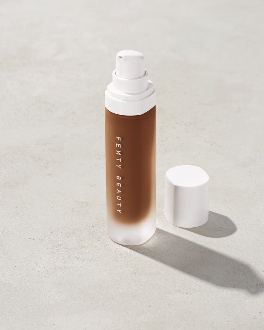 open bottle of Fenty Beauty Pro Filt'r Soft Matte Longwear Foundation with pump dispenser in shade 480 on concrete background