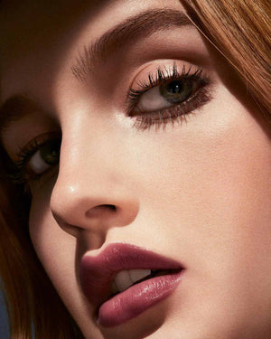 Slip Shine Sheer Shiny Lipstick light model shown in shade Vamps Who Brunch