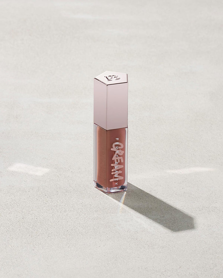 tube of Fenty Beauty Gloss Bomb Cream Color Drip Lip Cream lip gloss shown in shade Fenty Glow