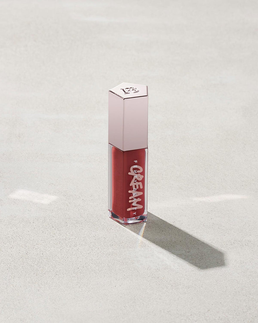 tube of Fenty Beauty Gloss Bomb Cream Color Drip Lip Cream lip gloss shown in shade Fruit Snackz