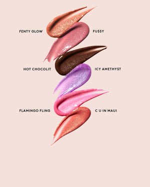 Swatches of Gloss Bomb Shimmers on a pink background.