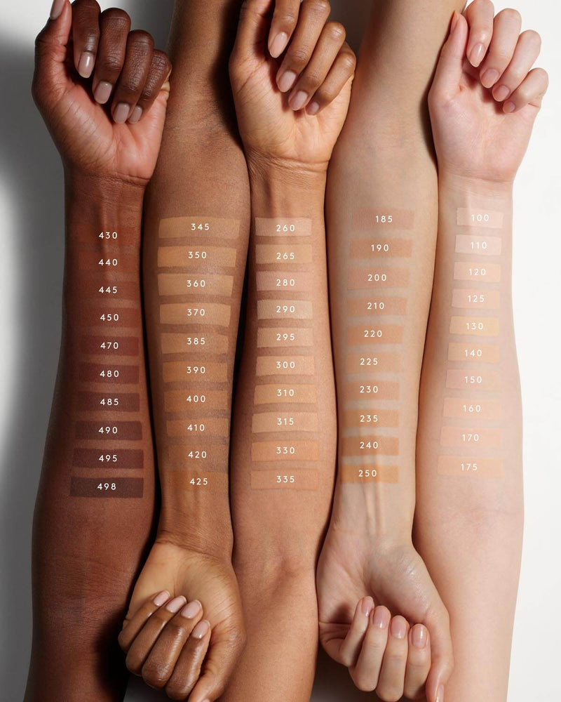 Fenty Beauty's collection of Pro Filt'r Soft Matte Longwear Foundation shades for light, light-medium, medium, medium-deep or tan, and deep skin tones shown as arm swatches on models of various skin tones