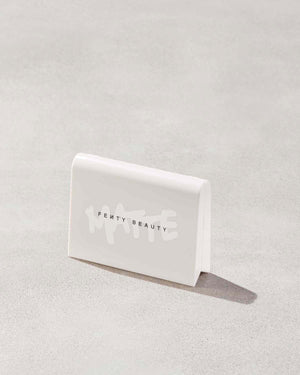 Invisimatte Instant Setting + Blotting Powder with closed packaging shown on a concrete background.