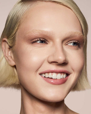 light skin toned model wearing gloss bomb universal lip luminizer in Fu$$y