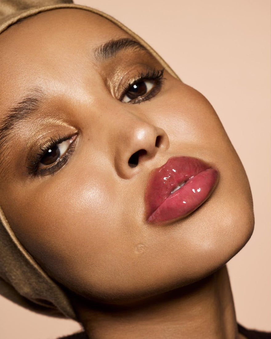 medium skin tone model wearing Gloss Bomb Heat Universal Lip Luminizer + Plumper in shade hot cherry