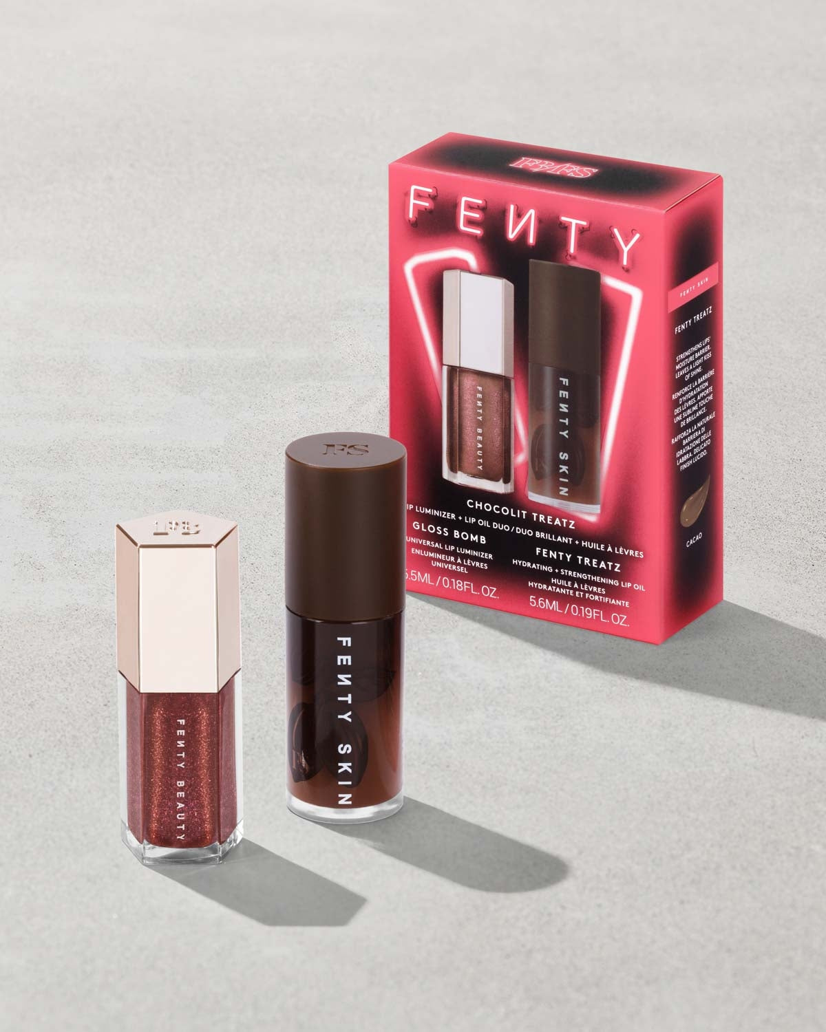 Fenty Skin products including a lip gloss and a box on a gray background
