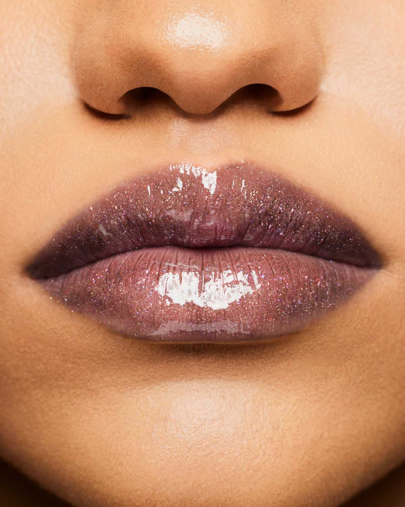 Product shot of Fenty Beauty Gloss Bomb Universal Lip Luminizer and packaging in limited edition Arcane collection shade Kaboom.