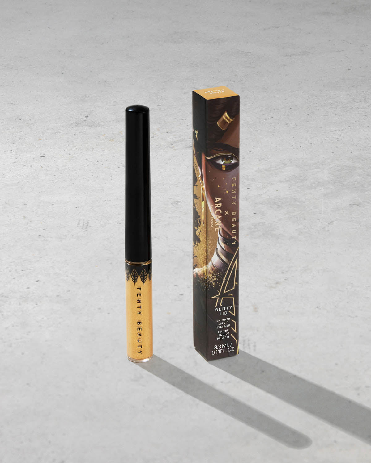 Product shot of Fenty Beauty Glitty Lid Eyeliner and packaging in limited edition Arcane collection shade Melodic Moves. 