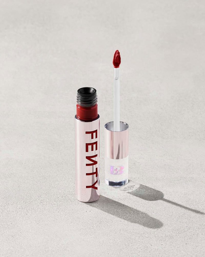 An open Fenty Icon Velvet lipstick tube on a light background.