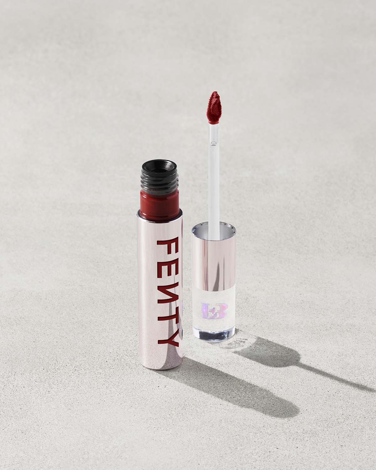 An open Fenty Icon Velvet lipstick tube on a light background.