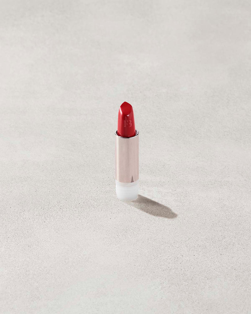 An open Fenty Icon refillable matte lipstick in the high-pigment shade, The MVP.