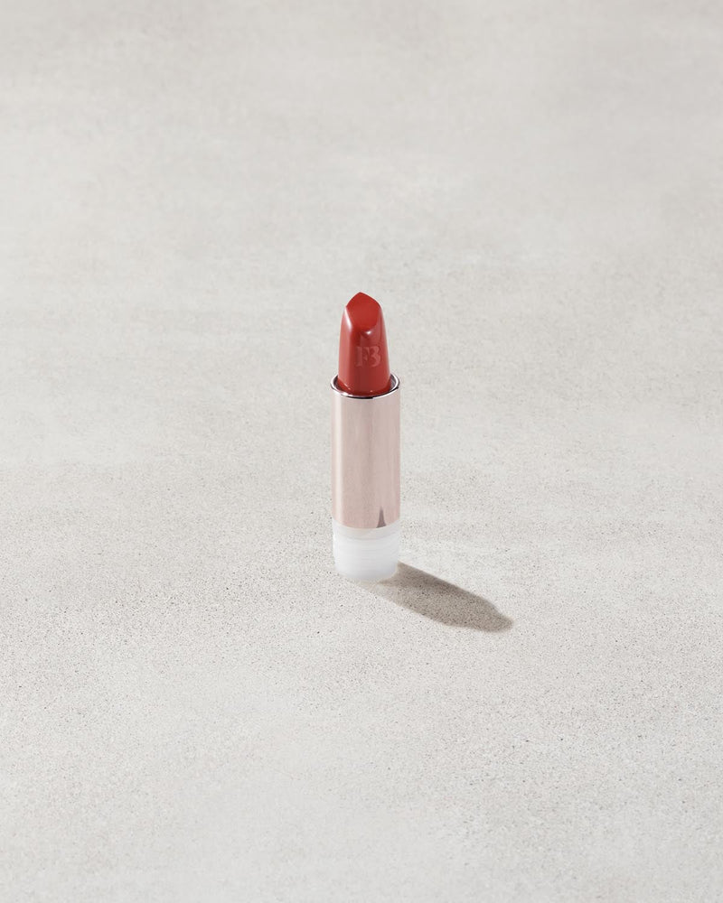 An open Fenty Icon refillable matte lipstick in the high-pigment shade, Grill Mast'r.