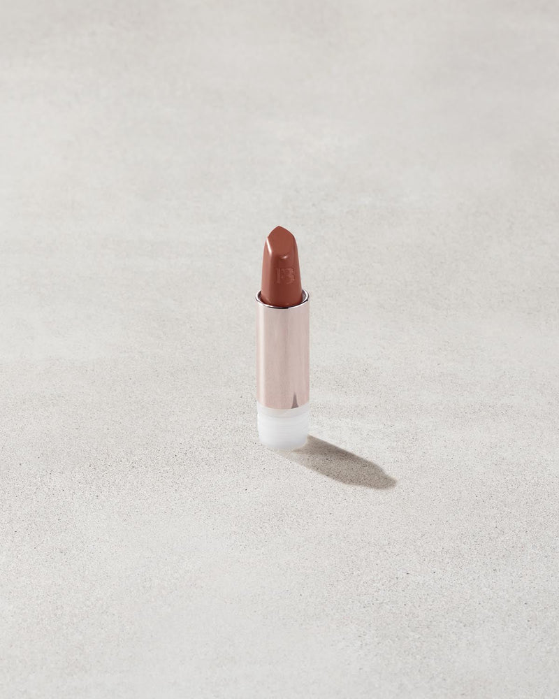 An open Fenty Icon refillable matte lipstick in the high-pigment shade, She a CEO.
