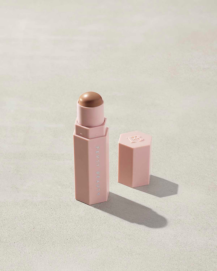 Opened Match Stix Contour Skinstick in the shade Amber Suede container on a grey background.