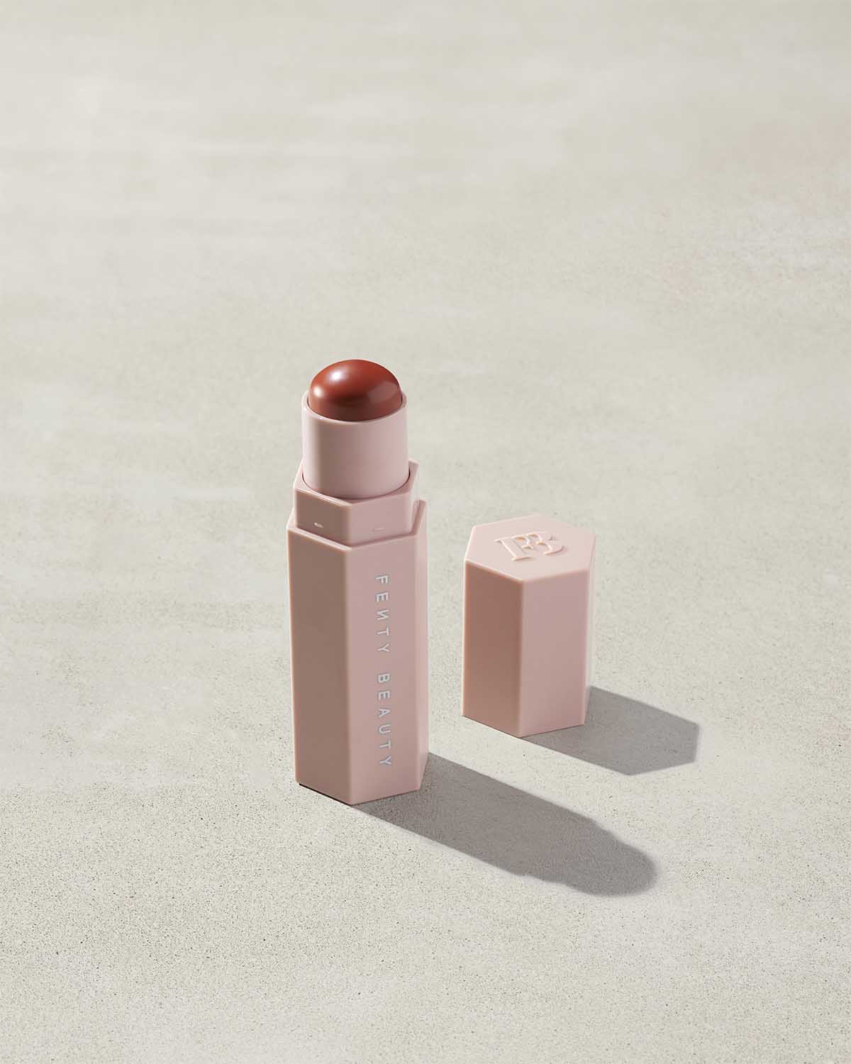 Match Stix Corrector Skinstick shown in shade Pumpkin with open packaging on a concrete background.