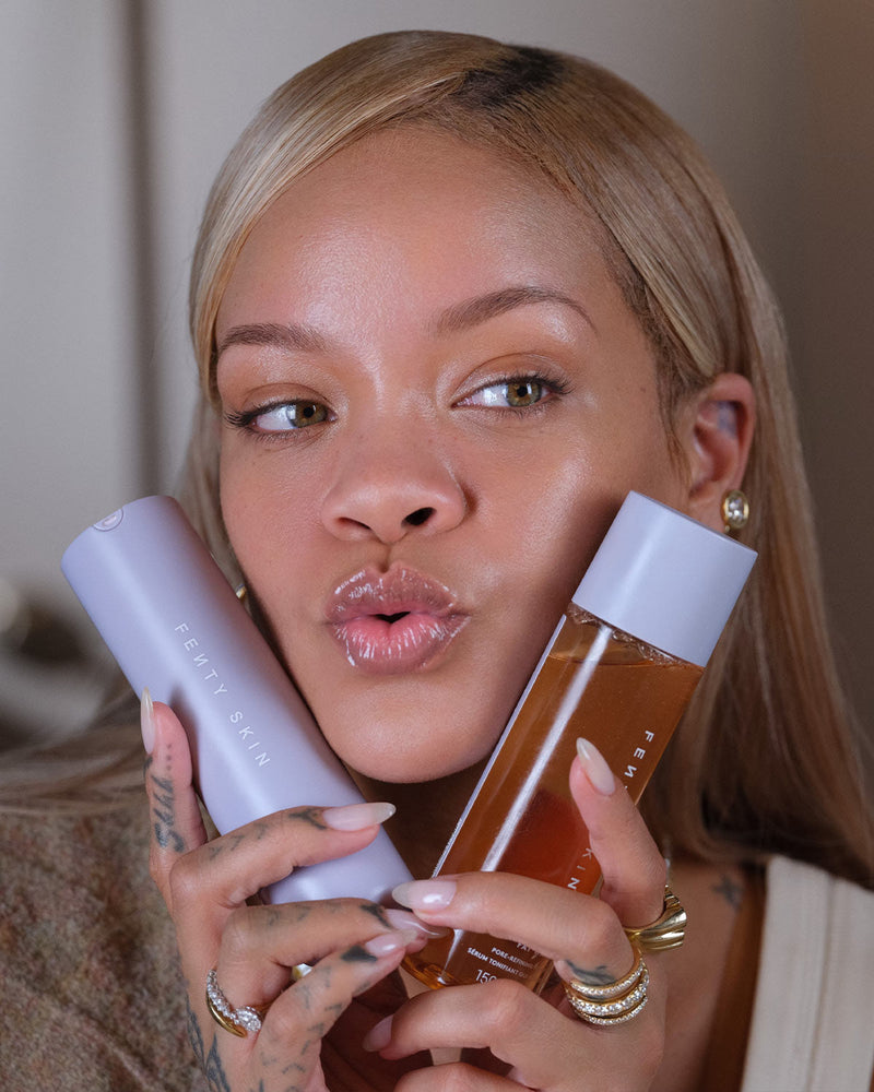 Rihanna holding Hydra Vizor Mineral SPF Moisturiser and Fat Water Pore Refining Toner Serum 