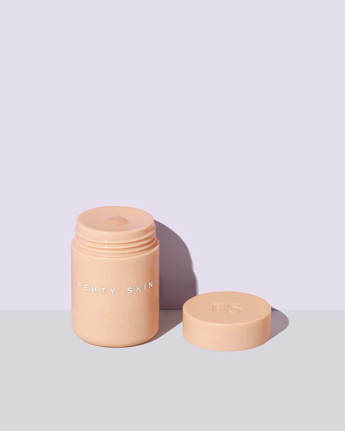 An open container of Plush Puddin' lip mask on a lilac background.